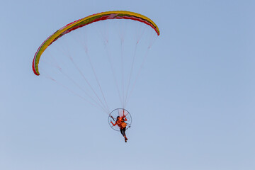 Paragliding pilot over blue sky