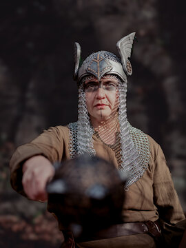 Female Viking in winged and chainmail armor and face paint holding a mace out in battle. 