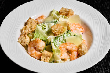 Indulge in a Delicious Shrimp Caesar Salad topped with Crispy Croutons and fresh Parmesan cheese