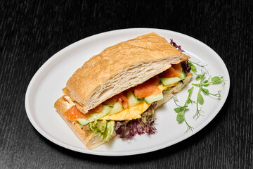 A Delicious and Fresh Sandwich Plated Beautifully with Various Colorful Vegetables