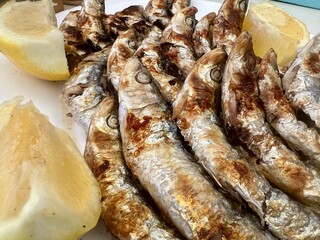 A plate of fish and lemon slices