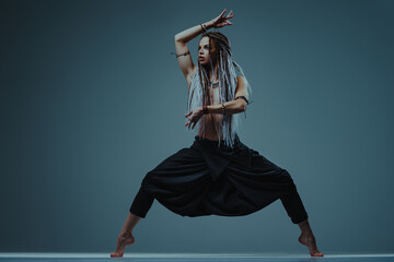 Young ethnic style woman with long hair studio posing