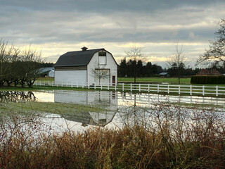 Flooded Farm and Barn. Heavy rains cause a flooded, muddy farm field.

