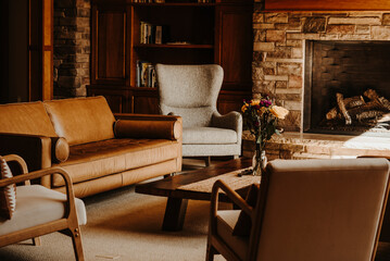 Cozy living room with a fireplace and chairs set for group conversations or a group therapy session