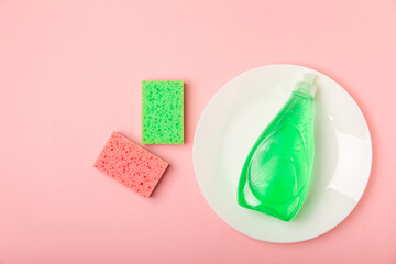Colorful dish sponges on textured background. Kitchen sponge. Cleaning concept, cleaning service. Dishwashing liquid with clean and dirty dishes plate. Place for text, copy space. Wash the dishes.