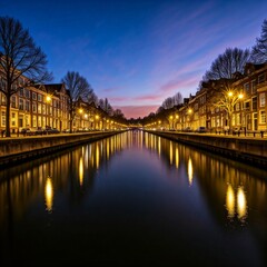 Evening lights reflecting on calm canal waters.
