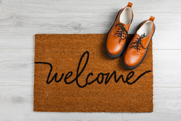 Doormat. Welcome mat on the floor background. Women's shoes on a doormat on background. Interior...