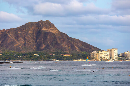 Leahi Diamond Head at Sunset with surfers in the foreground, Honolulu, O'ahu, Hawai'i
