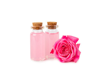 Rose essential oil isolated on white background.Roses and a bottle of rose perfumed water. Aromatherapy treatment. Beauty concept. Spa procedure.Natural organic oil.Anti-stress and detox relax.