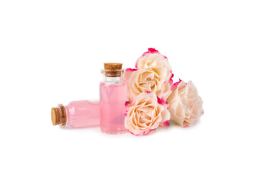 Rose essential oil isolated on white background.Roses and a bottle of rose perfumed water. Aromatherapy treatment. Beauty concept. Spa procedure.Natural organic oil.Anti-stress and detox relax.