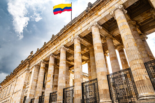 The Colombian Capitol Building stands tall, its majestic facade adorned with a waving Colombian flag. A symbol of democracy and national pride.