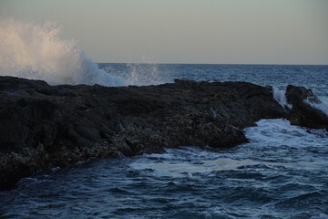 Autumn afternoon watching the sunset and waves from the cliff
