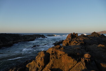 Autumn afternoon watching the sunset and waves from the cliff