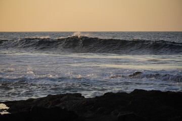 Autumn afternoon watching the sunset and waves from the cliff