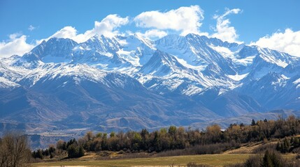 Majestic Snow-Capped Mountains Rise Against a Clear Blue Sky, Showcasing the Beauty of Nature in a Tranquil Setting