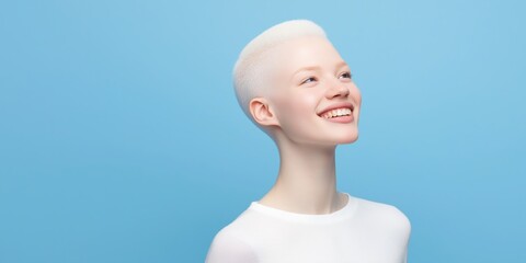 A woman with a shaved head and a white shirt is smiling. Concept of happiness and positivity