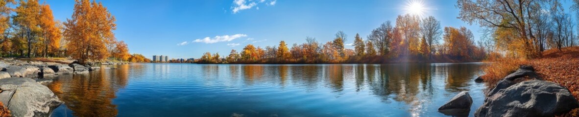 Fototapeta premium Tranquil Autumn Landscape Reflecting Vibrant Foliage Beside a Serene Lake Under Clear Blue Skies in Early Afternoon Light