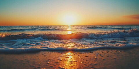 The sun sets gently over serene waves and calm beach waters.