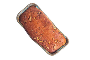 Top view of freshly baked banana bread with nut toppings in a cardboard box.