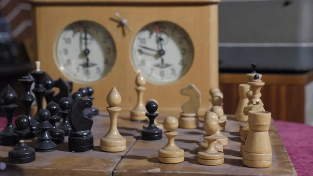 Retro Chess Pieces On Dusty Chessboard, Old Chess Clock. Close-Up 
