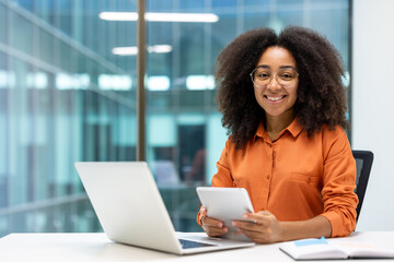 Portrait of young female programmer inside office at workplace, businesswoman smiling and looking...