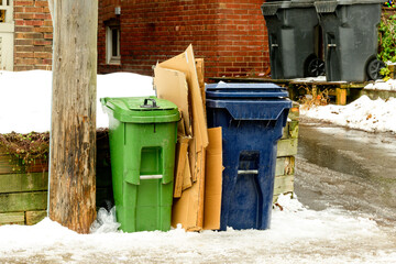 green economy: compost and recycling bins waiting for collection on a residential street shot in...