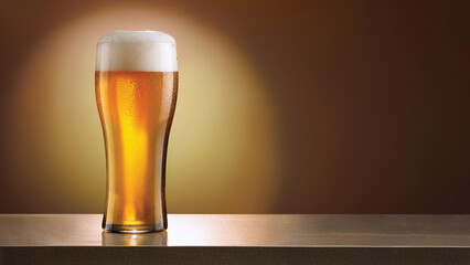 Glass of Beer Sitting on a Wood Counter with a Spotlight Shining on it