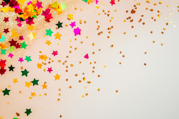 ruby star confetti sprinkled on rose-toned backdrop, space for text