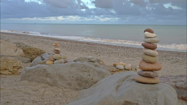 A duo of apachetas, stone mounds beside the Mediterranean Sea, Spain.