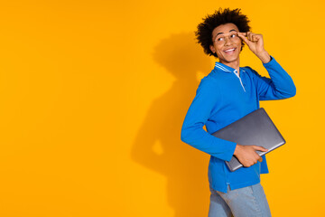Photo portrait of handsome young guy walk hold netbook look empty space dressed stylish blue...