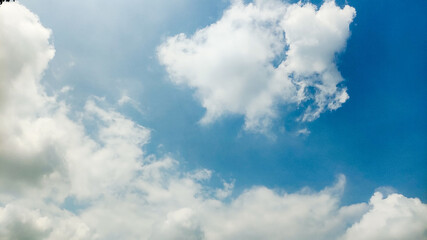 Focus on clouds. The sky was bright blue with pure white clouds like soft cotton. Full frame shot. Clear sky blue sky background