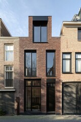 Fototapeta premium This contemporary brick home features a minimalist architectural style, set in a tranquil urban environment, beautifully illuminated by daylight