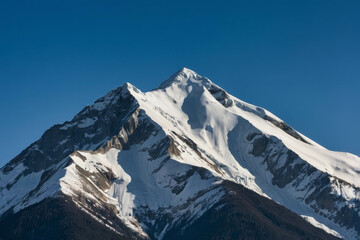 a snowy mountain peak against a clear blue sky