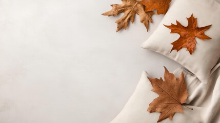 Neutral workspace, linen cushions, dried leaves