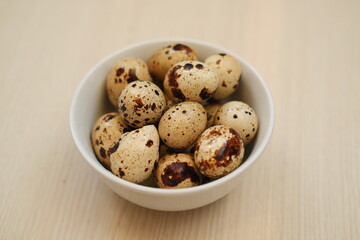 Quail eggs on a wooden table. Close-up, selective focus