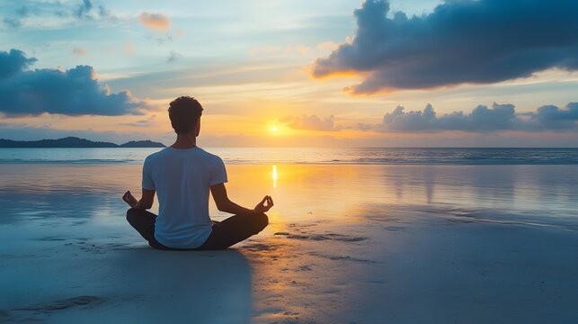 Man Meditates on Beach at Sunset