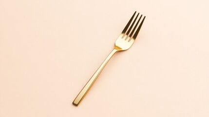 A golden fork placed on a soft pastel background.