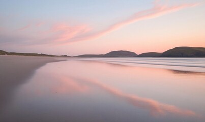 Fototapeta premium Serene beach landscape at sunset with soft reflections.