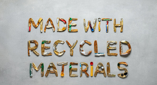 Recycled materials made with colorful recycled items creative text on grey background