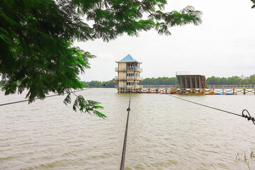 Tranquil Lakeside Structure Featuring a Blue Roof and an Unfinished Staircase
