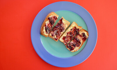 Toasted white bread with butter and blackberry jam.