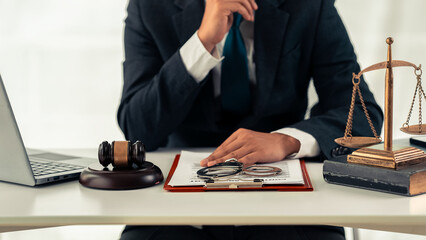 Lawyer working with scale of justice on table, law, court, judge, balance, symbol, judgment, power, court scale, power symbolizes judgment with hammer and injustice.