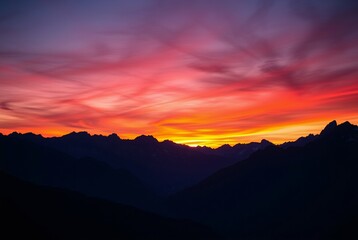 Obraz premium Breathtaking Sunset Over Majestic Mountain Range with Colorful Sky