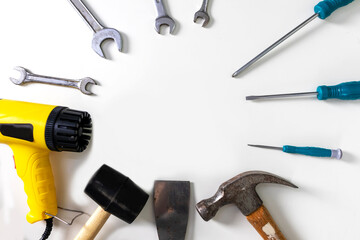 Set of tools and equipment, screwdrivers of various sizes, hammer and blower on white background.