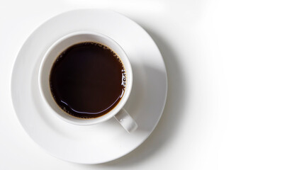 White cup and black coffee on white table in top view
