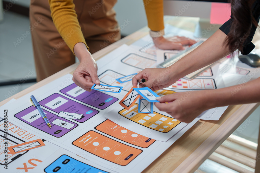 Poster web designers collaborating on developing a mobile application, arranging various options for the us