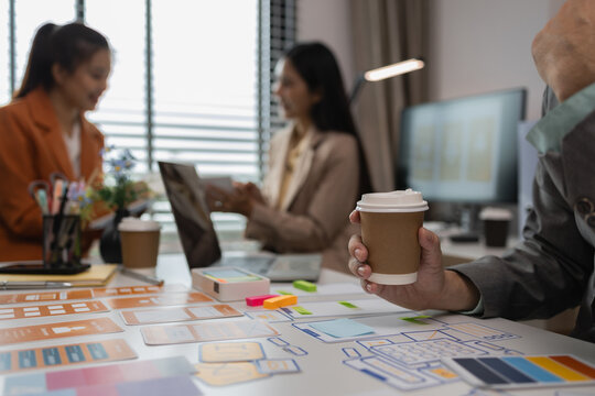 drawing website ux ui app for mobile phone application and development template layout, UI development, designer team working on a project of ux ui in creative office, team of creative web