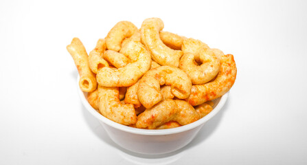 Fried macaroni served in a white bowl isolated on white background. Savory fried macaroni in Indonesia