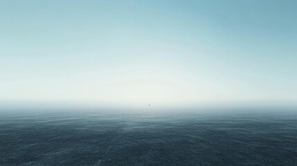 Obraz premium Endless ocean view under a soft blue sky at dawn.