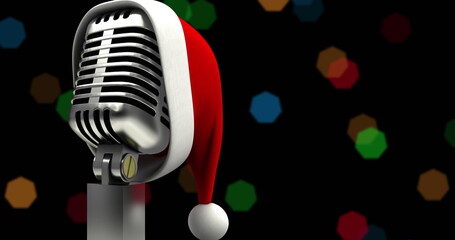 Image of santa claus hat on retro microphone and christmas fairy lights over black background